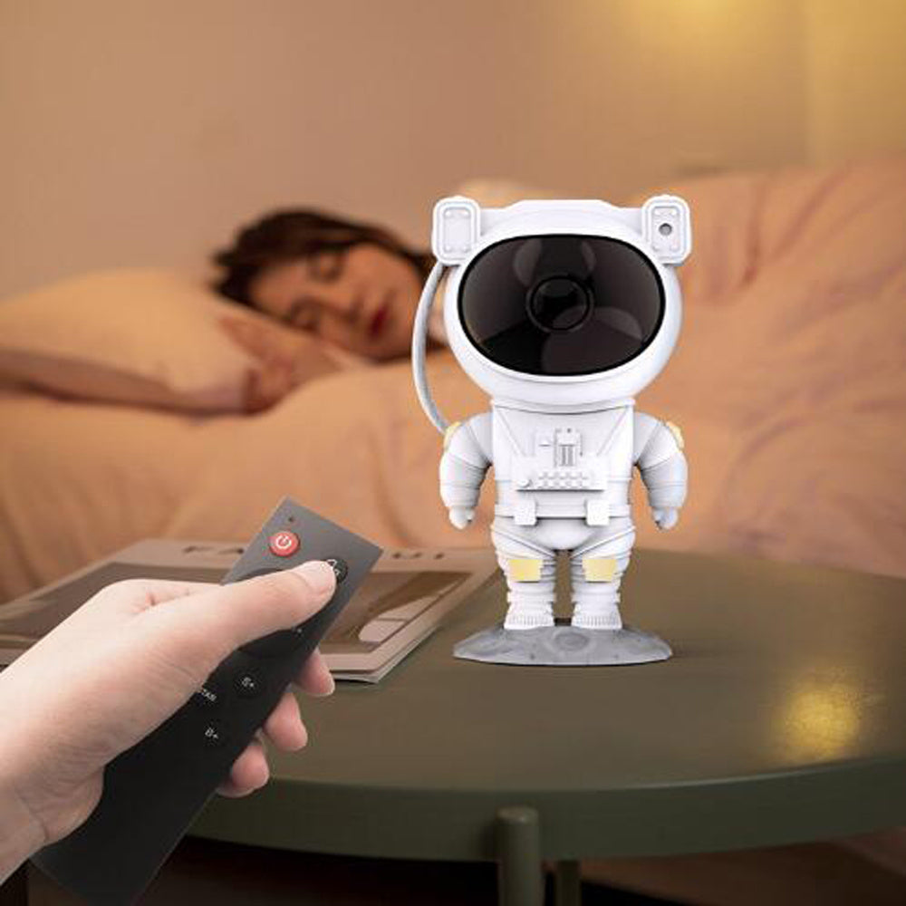 Sheila Merchandise astronaut galaxy projector lamp on table with person using remote control in bedroom
