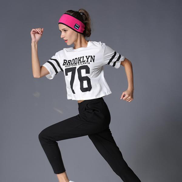 Sheila Merchandise Bluetooth fitness headband in pink worn by woman running in athletic outfit
