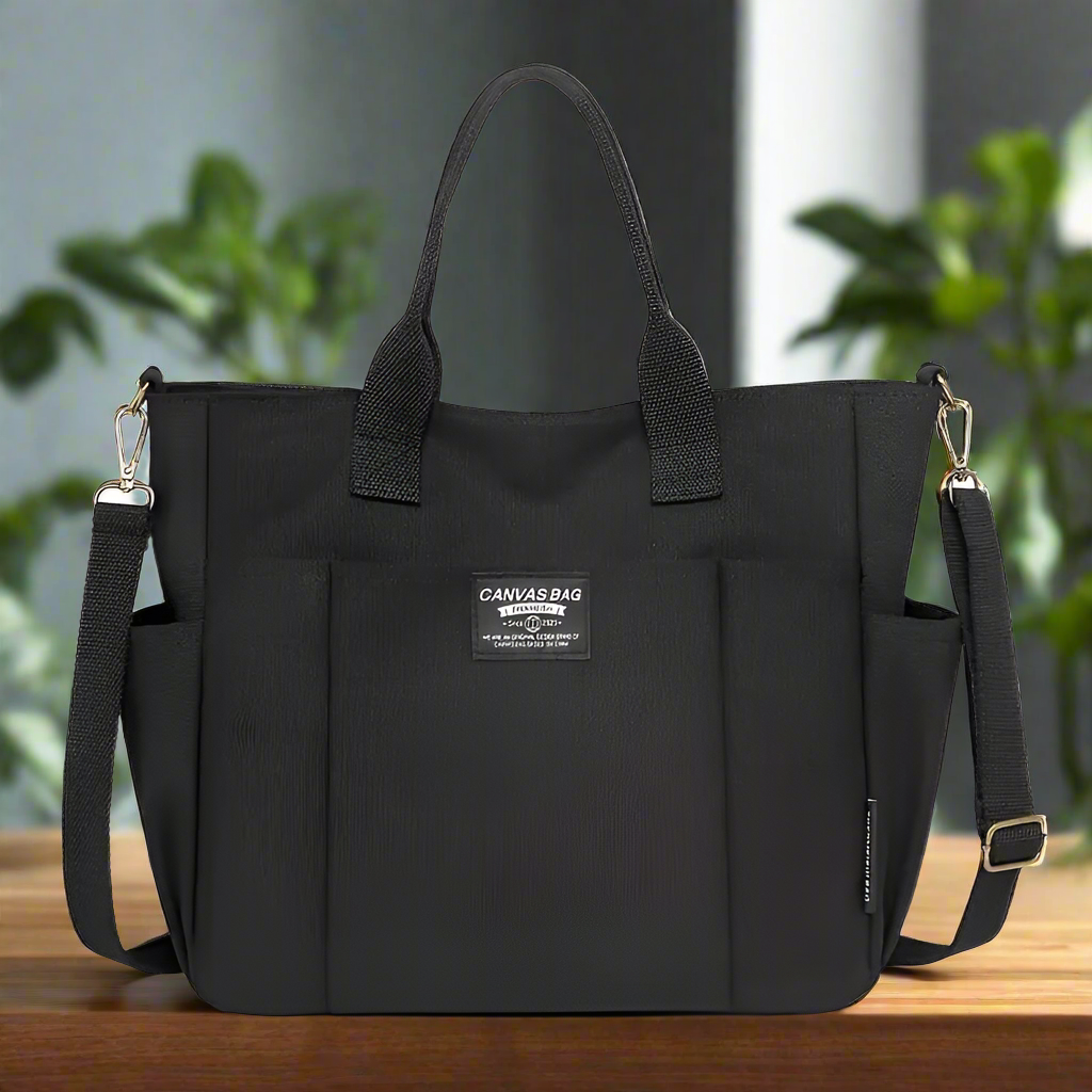 Black multi pocket shoulder bag for women with adjustable strap and sturdy handles