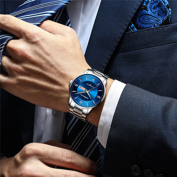 Men's high-quality business watch with silver metal band and blue dial worn with formal suit