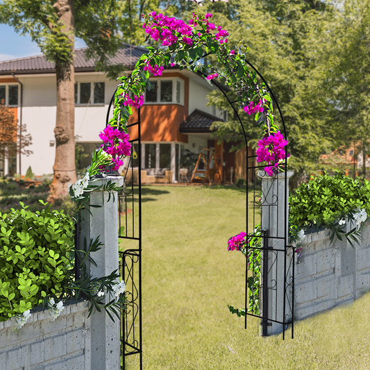 Elegant decorative garden arch for climbing plants adorned with vibrant flowers in a lush outdoor setting