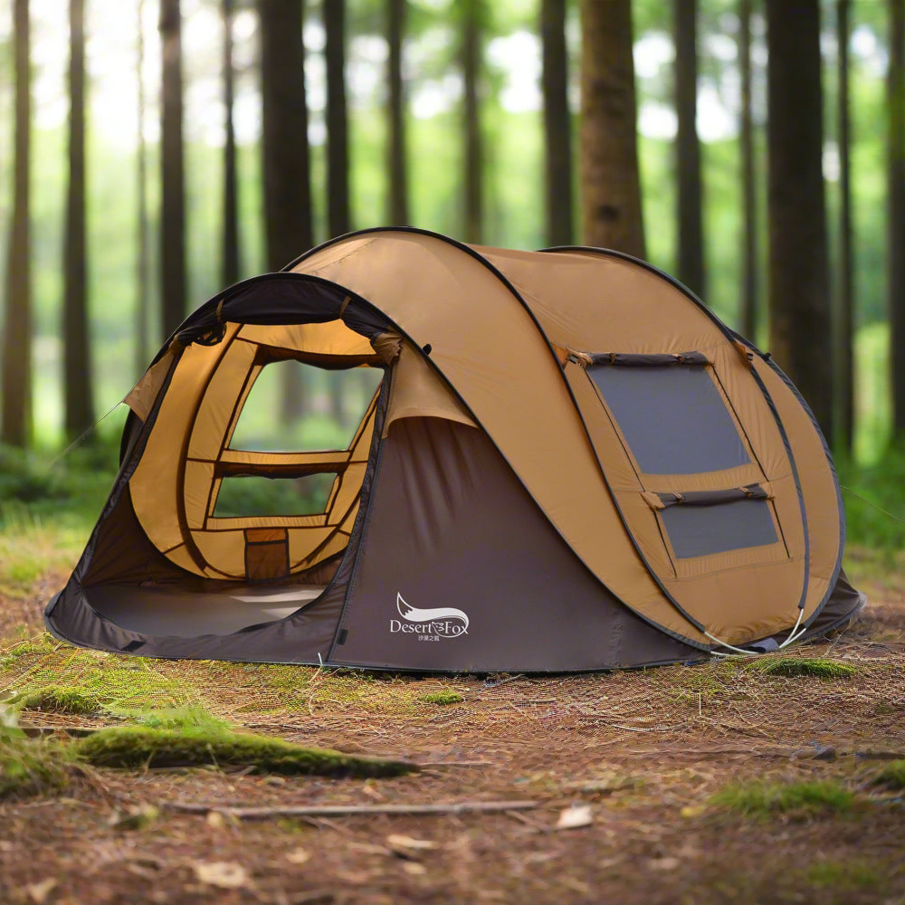Outdoor automatic tent for 3-4 people in brown set up in a forest with mesh windows