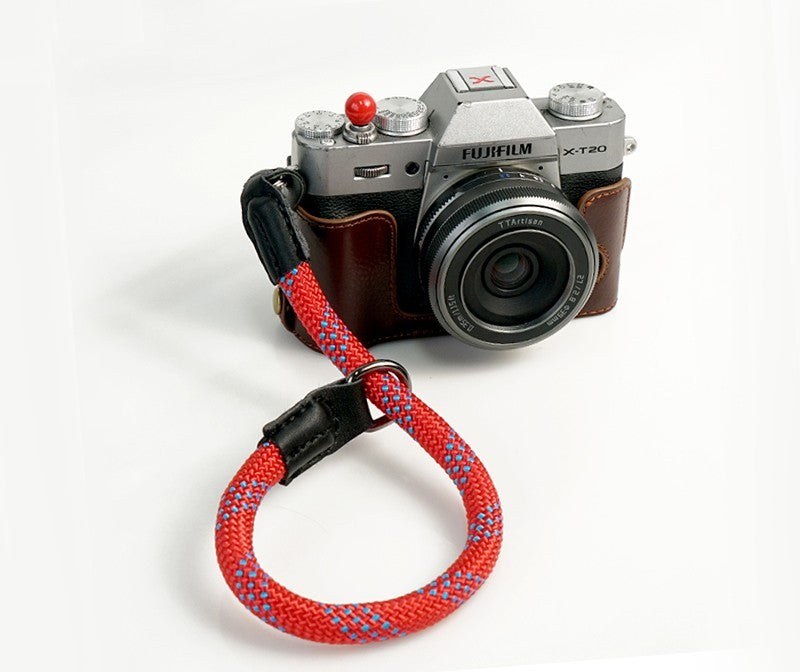 Durable camera wrist strap in red and blue braided design attached to a Fujifilm X-T20 camera by Sheila Merchandise