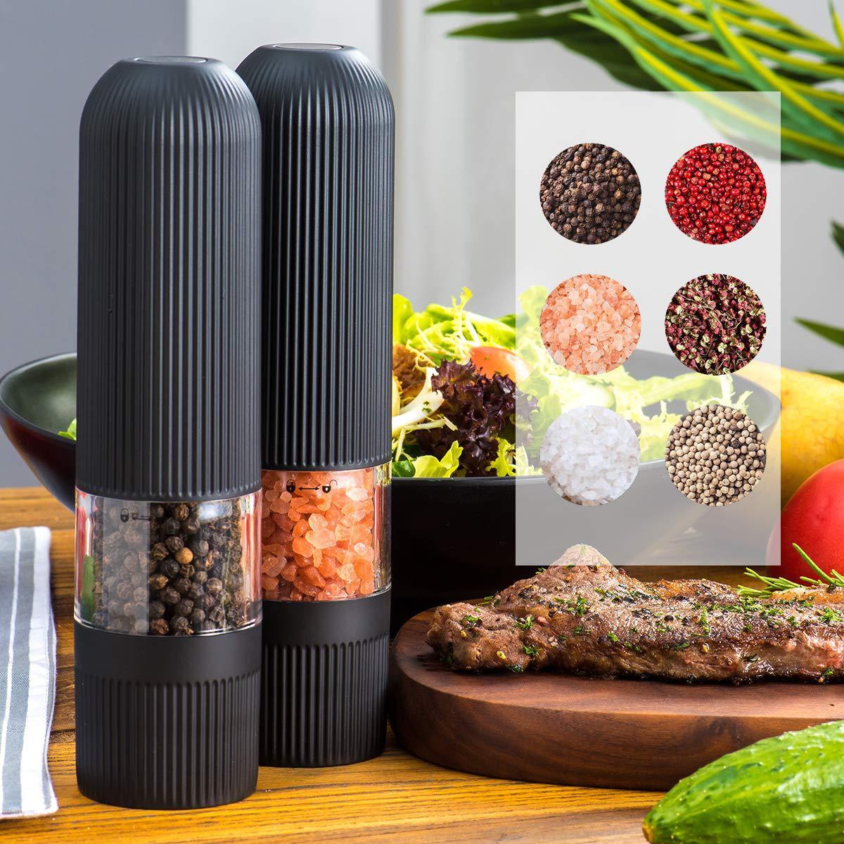 Sheila Merchandise electric pepper grinder set with black ribbed design and clear spice containers on wooden table