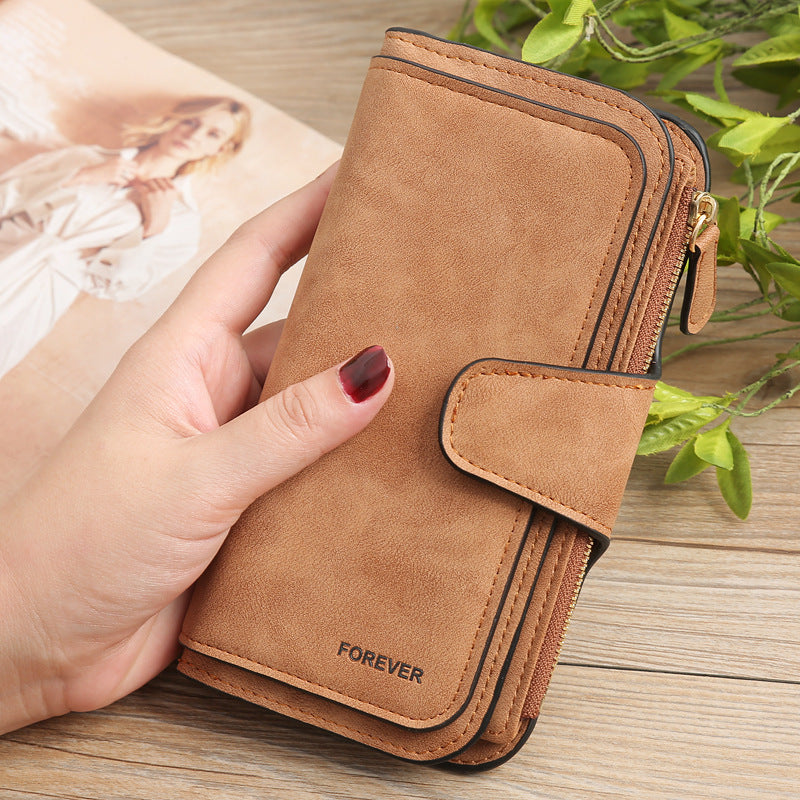 Sheila Merchandise matte PU leather multi function wallet for women in brown held in hand