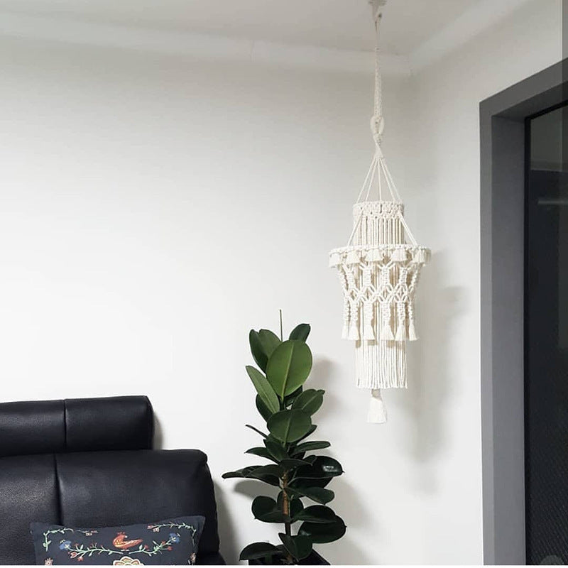 Handmade home lighting decor macrame hanging lamp in white near black sofa and green plant