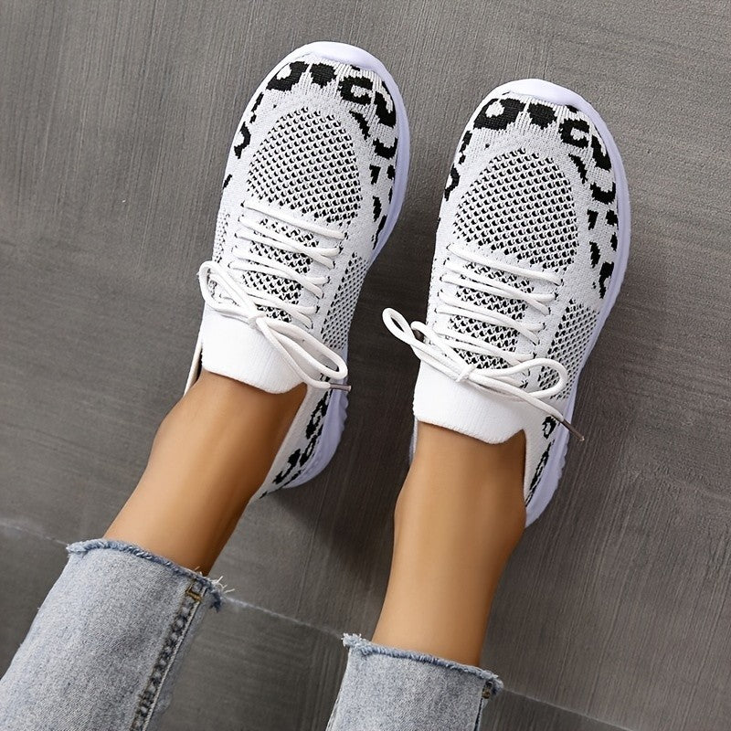 White lace-up leopard print sneakers women with breathable knit design worn with denim jeans