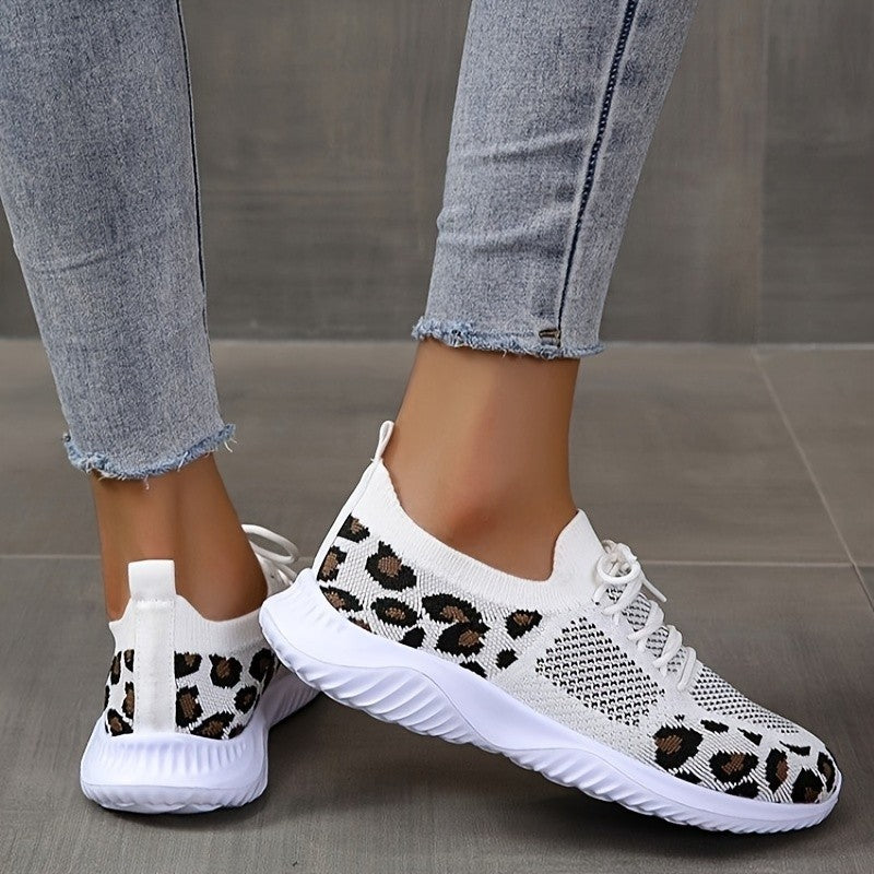 White leopard print sneakers women with lace-up design and flexible sole worn with denim jeans