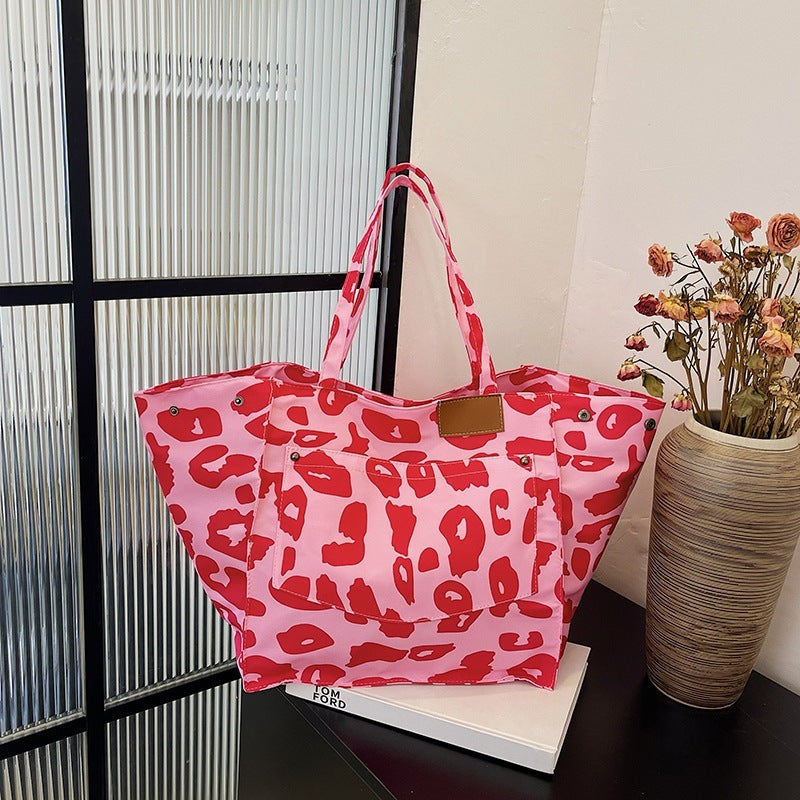 Popular leopard print tote bag in red and pink with large capacity and sturdy handles by Sheila Merchandise