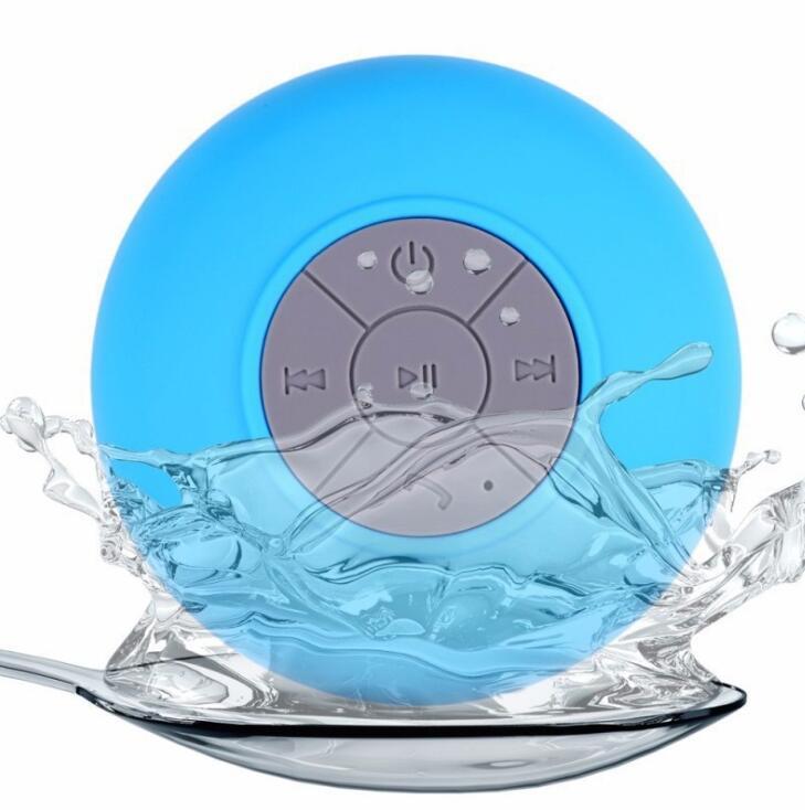 Sheila Merchandise mini waterproof Bluetooth speaker in blue with control buttons splashing in water