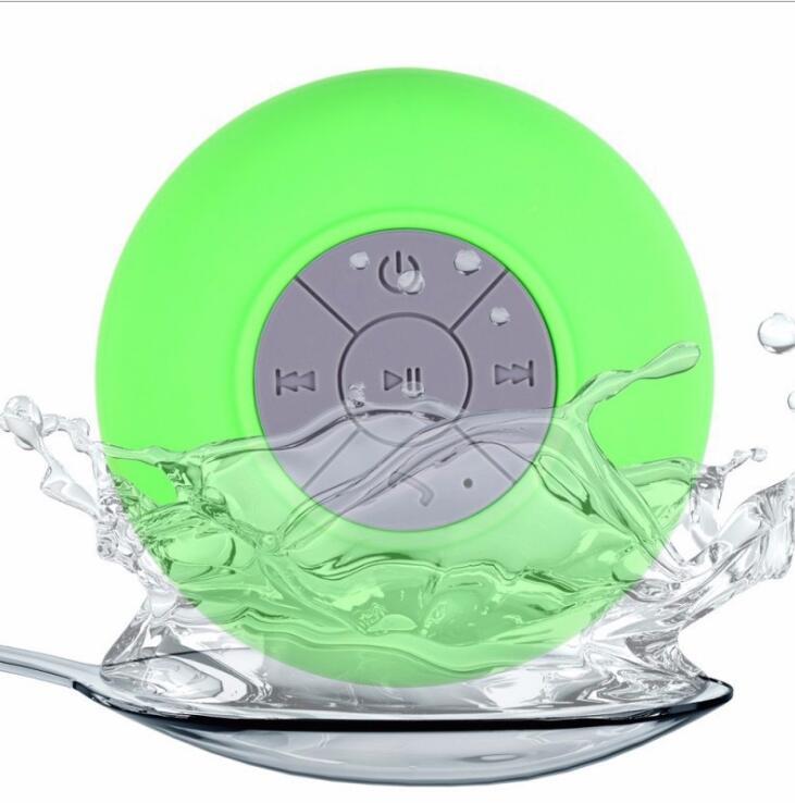 Sheila Merchandise mini waterproof Bluetooth speaker in green with control buttons splashing water