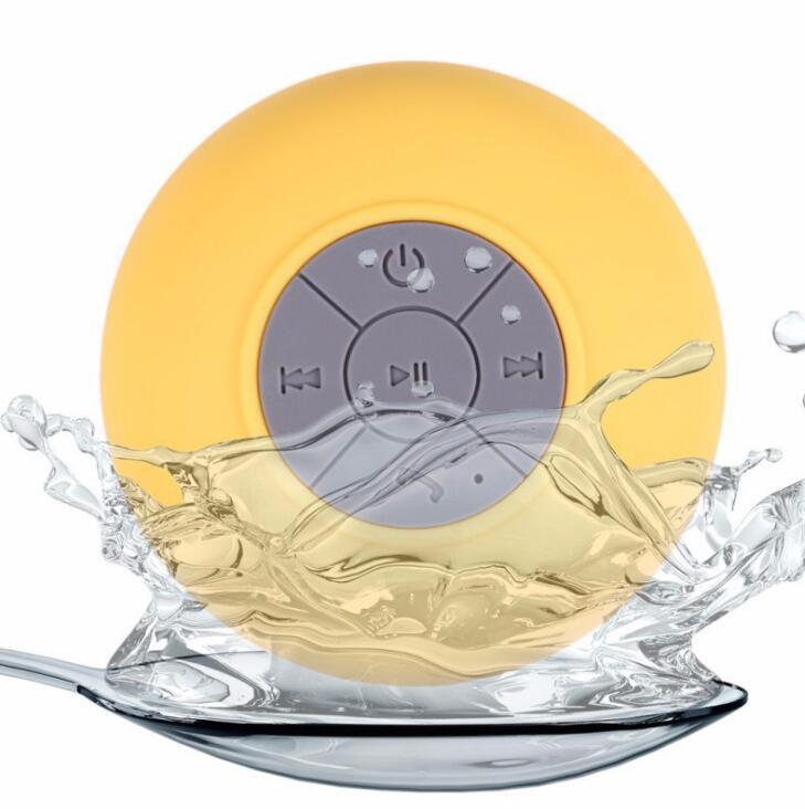 Sheila Merchandise mini waterproof Bluetooth speaker in yellow with water splash showing water resistance