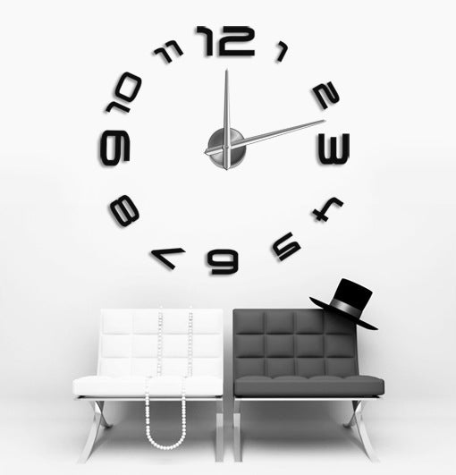 Luxury acrylic wall clock oversized design with black numbers mounted on white living room wall above black and white chairs