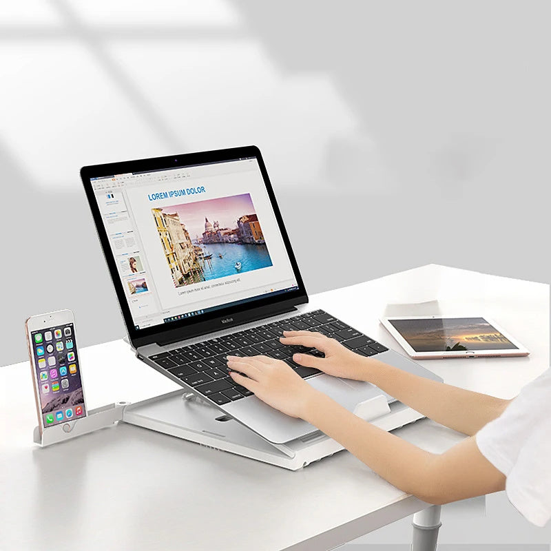 Portable laptop stand aluminum on a desk with a laptop and smartphone for ergonomic viewing