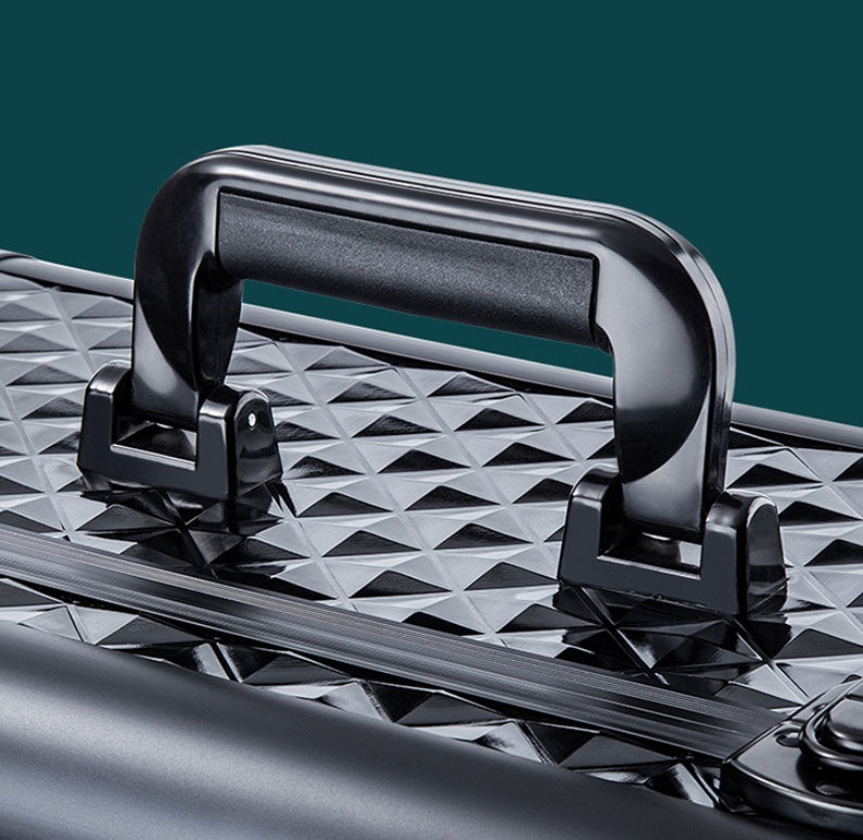 Close-up of black handle on Sheila Merchandise portable makeup organizer with wheels featuring textured surface