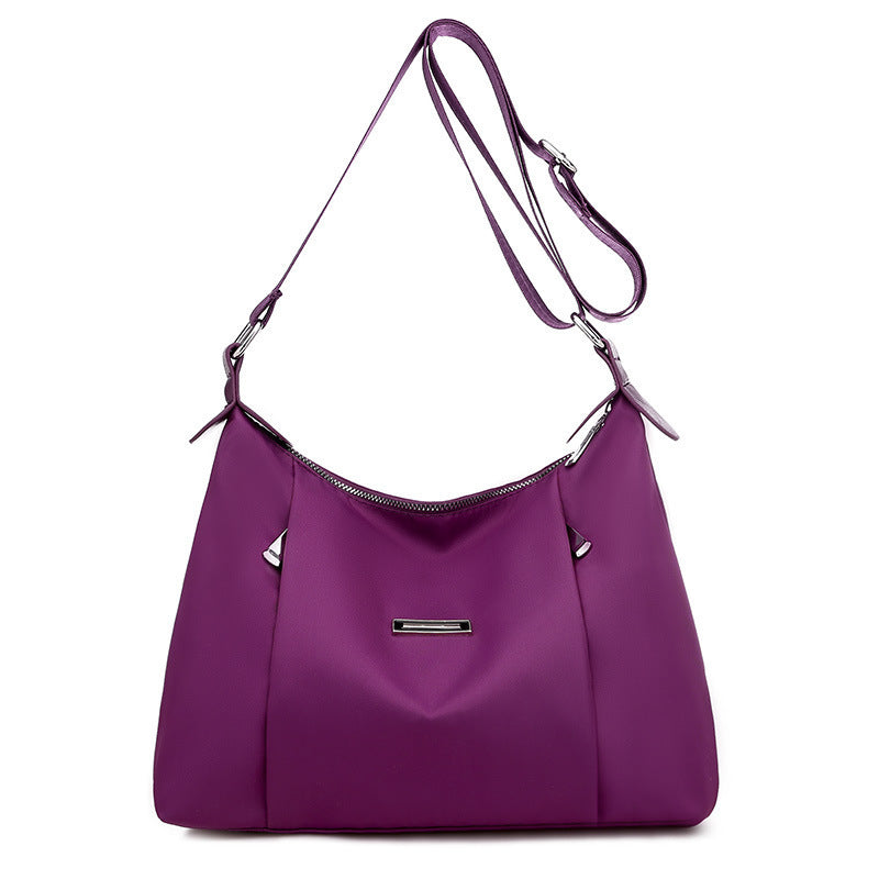 Purple everyday fashion handbag for women with adjustable shoulder strap and silver accents