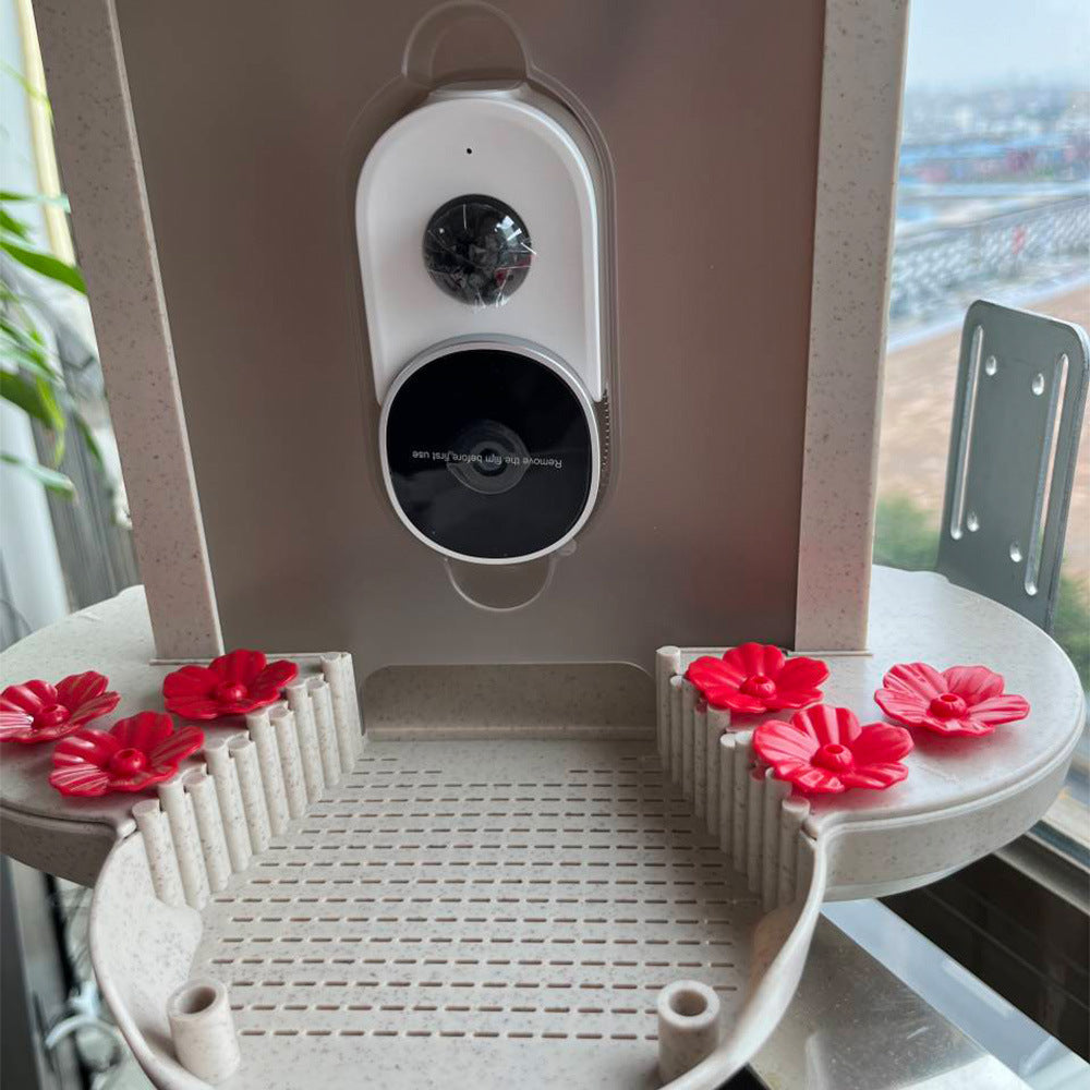 Smart hummingbird feeder with red flower feeding ports and built-in camera for birdwatching enthusiasts