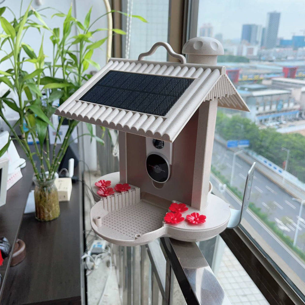 Smart hummingbird feeder with solar panel and red flower feeding ports for attracting birds