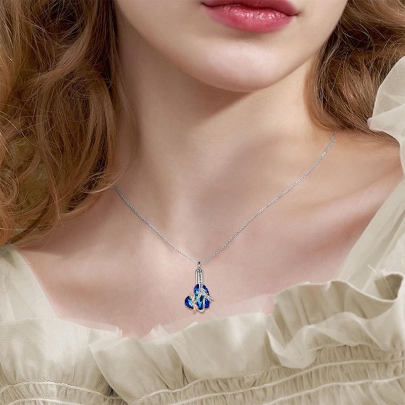 Sterling silver dragonfly urn necklace with blue crystal pendant worn on a woman’s neck