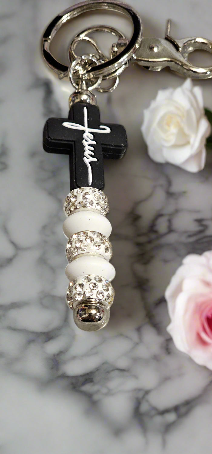 Stylish keychains for coffee enthusiasts featuring a black cross and decorative beads