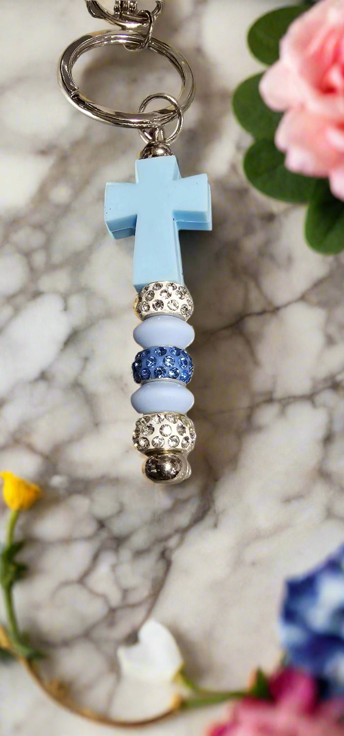 Stylish keychains for coffee enthusiasts featuring a blue cross and decorative beads