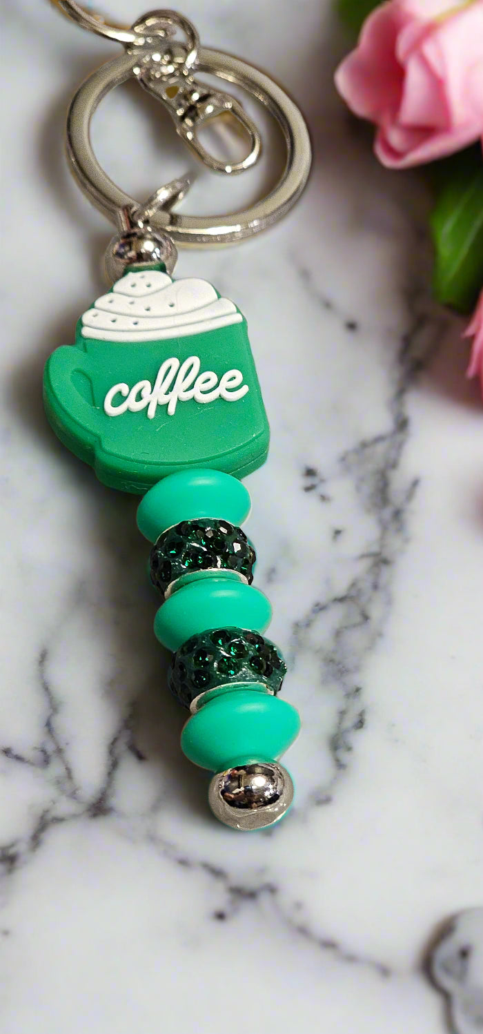 Stylish keychains for coffee enthusiasts featuring a coffee cup charm and decorative beads