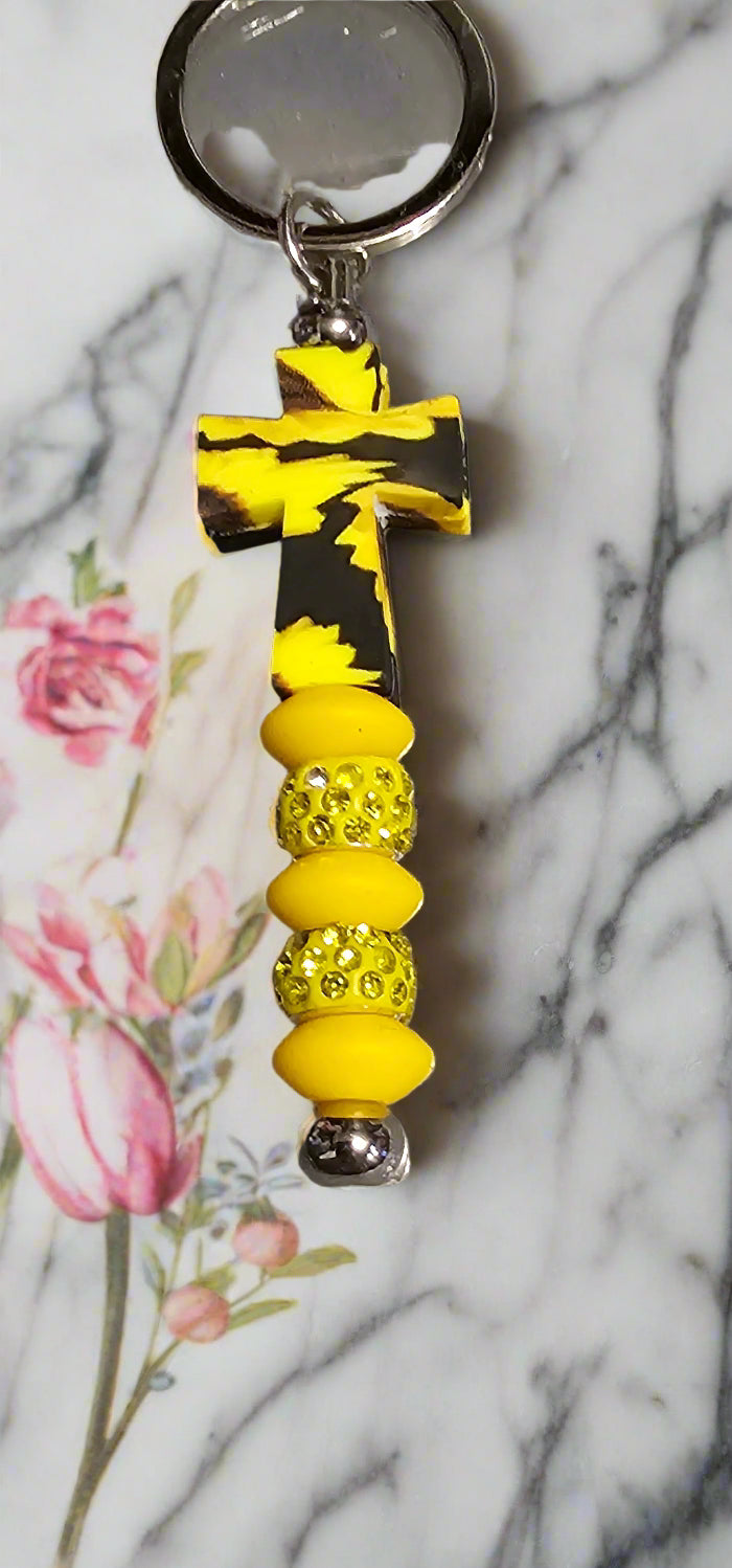 Vibrant yellow and black stylish keychain for coffee enthusiasts with cross design and decorative beads