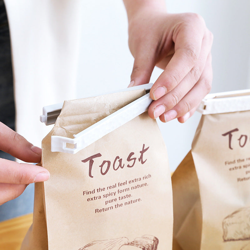 Reusable food sealing clips from Sheila Merchandise securing a brown paper toast bag for freshness