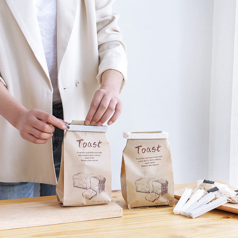 Reusable food sealing clips from Sheila Merchandise sealing toast bags on wooden table