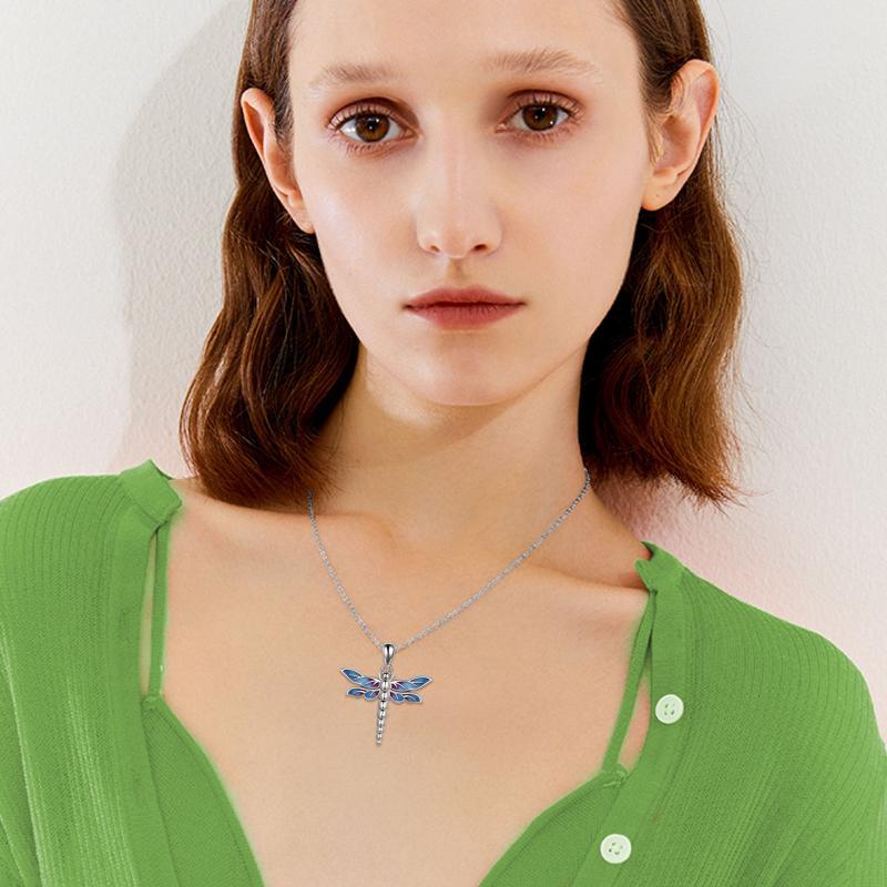 Sterling silver dragonfly urn necklace worn by woman in green top with blue wings detail