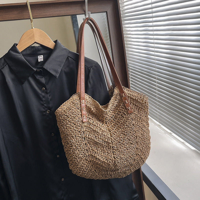 Sheila Merchandise summer fashion shoulder bag woven tote with brown leather straps hanging beside black shirt