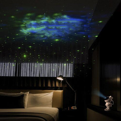 Astronaut galaxy projector lamp casting green and blue starry sky projections in a dark bedroom