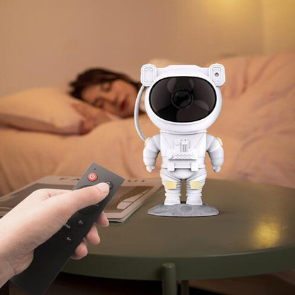 Sheila Merchandise astronaut galaxy projector lamp on table with person using remote control in bedroom