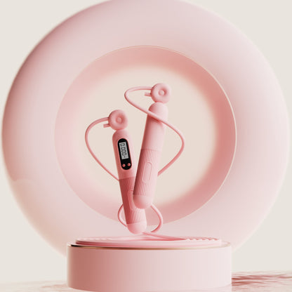 Pink cardio jump rope with counter and adjustable handles displayed on a round pink pedestal