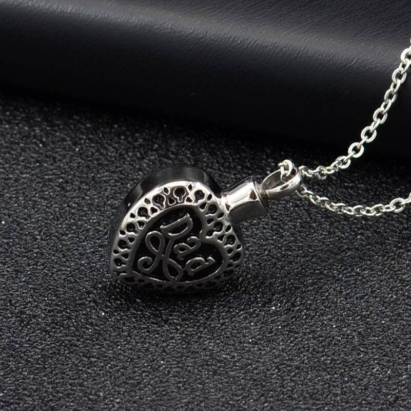 Silver heart urn pendant for ashes with intricate filigree design on a delicate chain