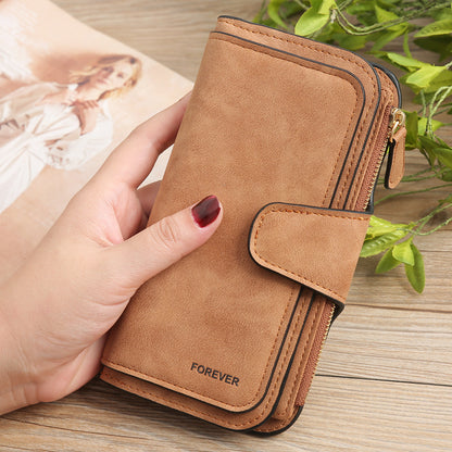 Sheila Merchandise matte PU leather multi function wallet for women in brown held in hand