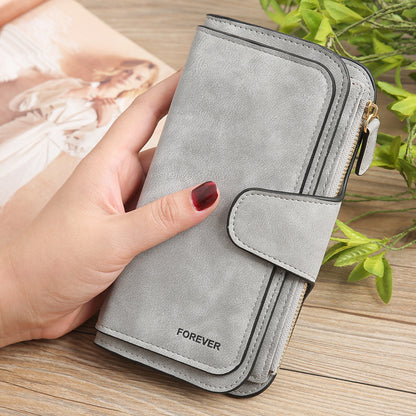 Sheila Merchandise matte PU leather multi function wallet for women in gray held in hand