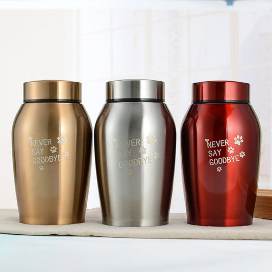 Three stainless steel pet urns in gold silver and red colors with Never Say Goodbye text and paw prints