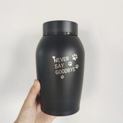 Black stainless steel pet urn with never say goodbye text and paw prints held in hand