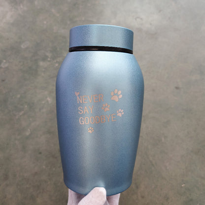Blue stainless steel pet urn with Never Say Goodbye text and paw print design