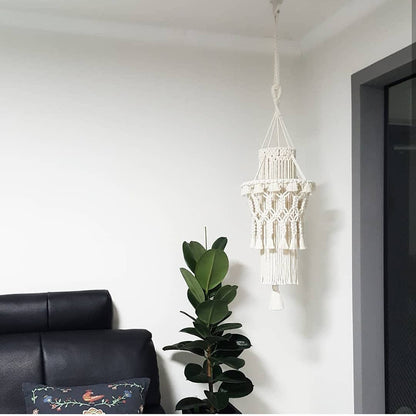Handmade home lighting decor macrame hanging lamp in white near black sofa and green plant