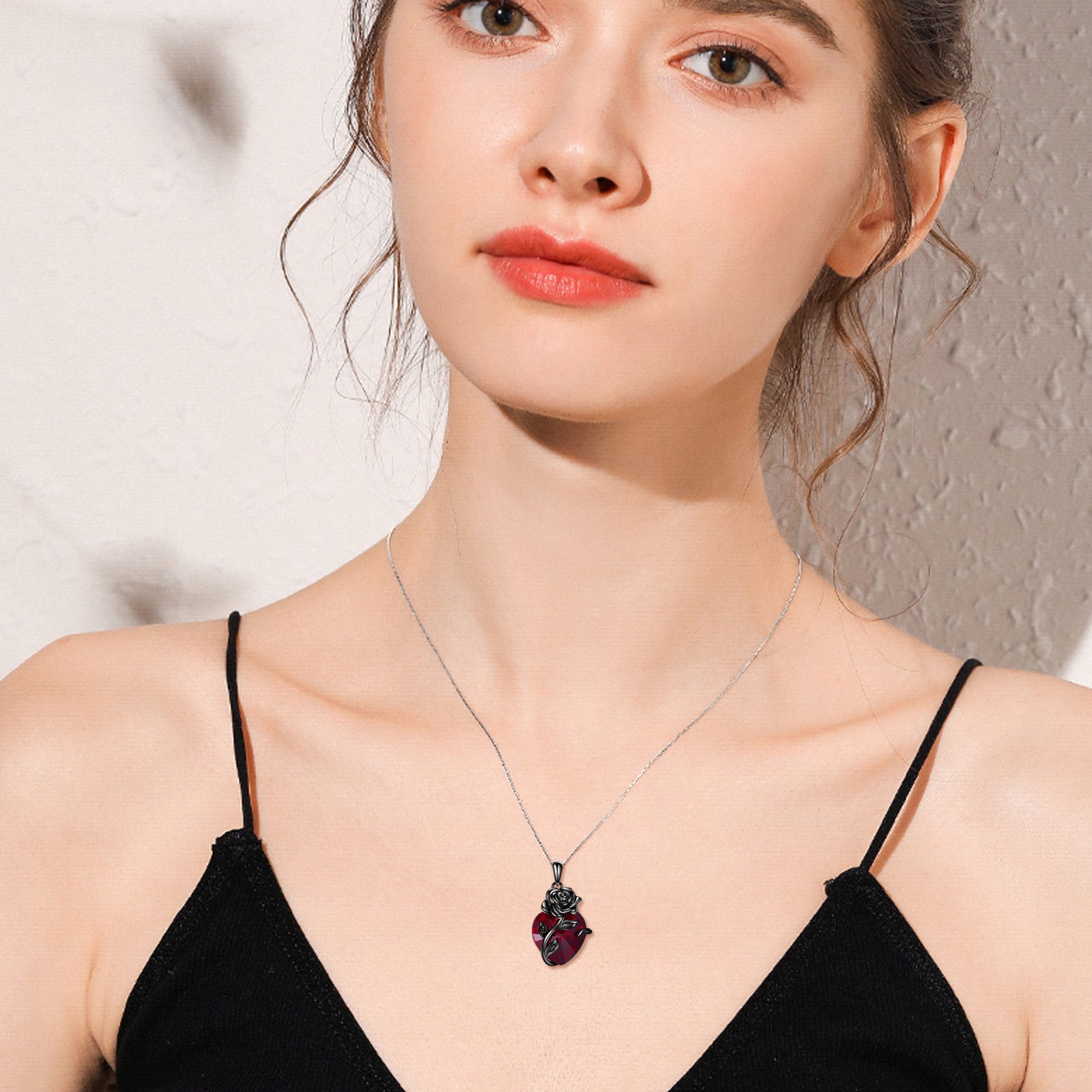 Sterling silver heart rose urn pendant for ashes worn by woman with black top