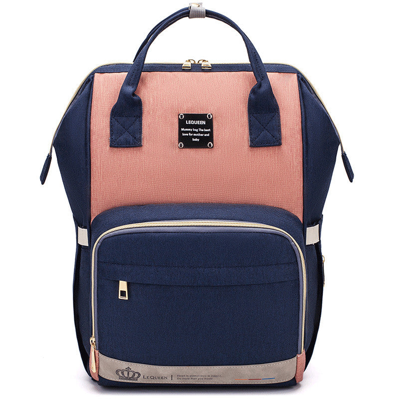 Sheila Merchandise parent-approved diaper backpack in navy and pink with multiple compartments and sturdy handles