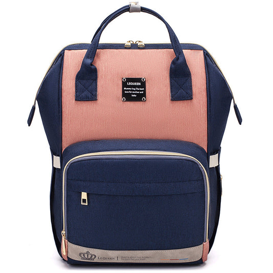 Sheila Merchandise parent-approved diaper backpack in navy and pink with multiple compartments and sturdy handles