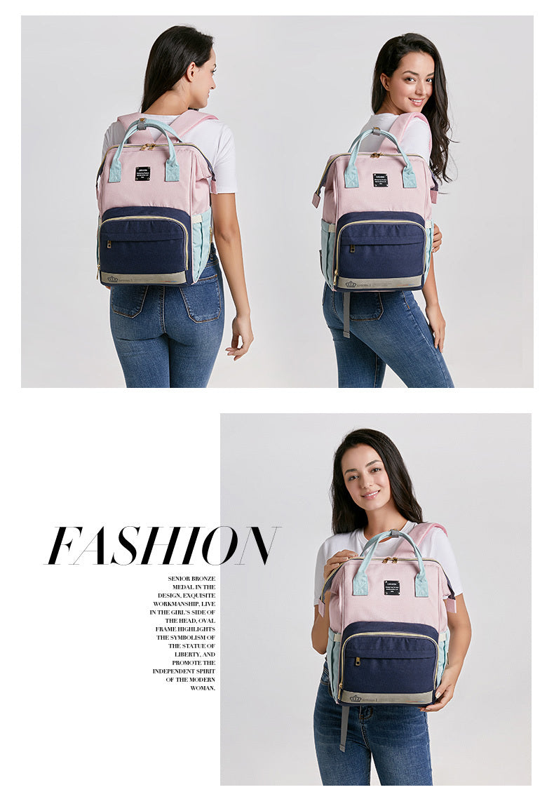 Sheila Merchandise pink and navy parent-approved diaper backpack worn by woman displaying spacious design