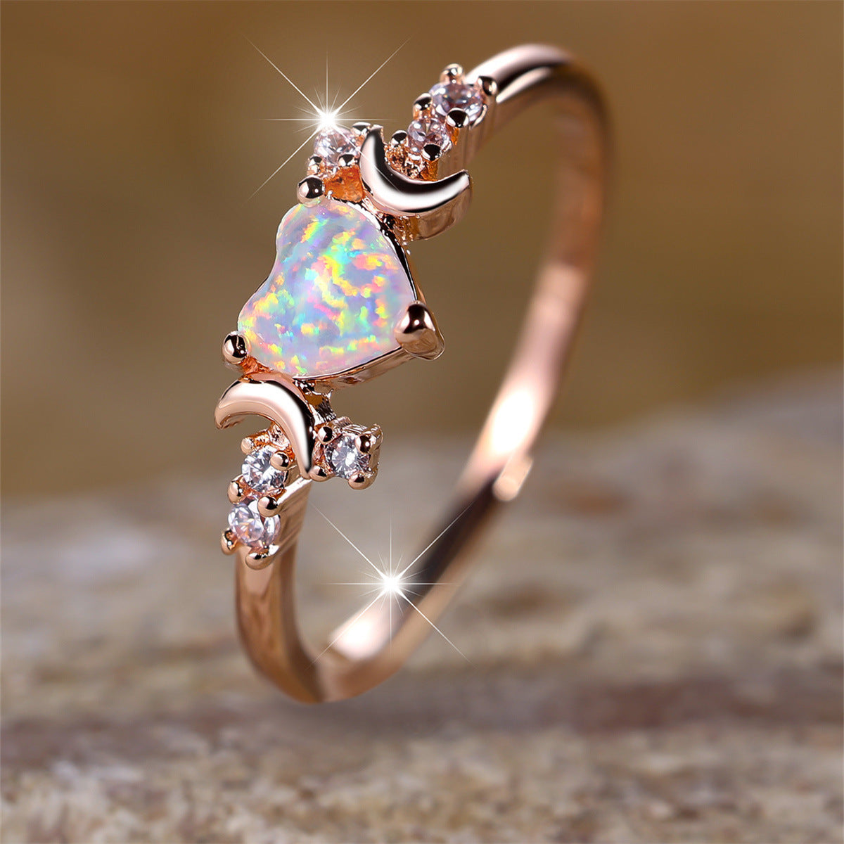 Rose gold moonstone love ring with a heart-shaped moonstone centerpiece and crescent moon accents