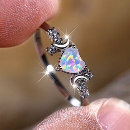 Moonstone love ring with heart-shaped stone and crescent moon design in silver setting