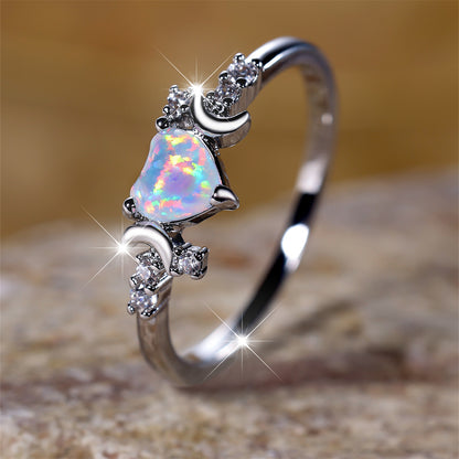 Moonstone love ring with heart-shaped opal and crescent moon accents in silver setting