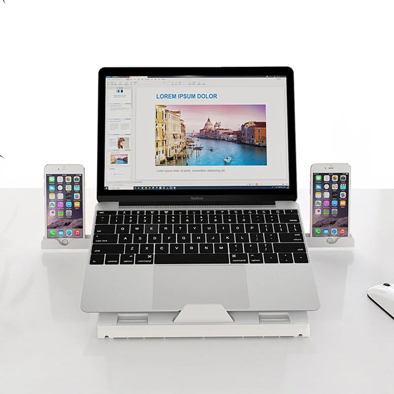 Portable laptop stand aluminum elevating a laptop with two smartphones on a white desk