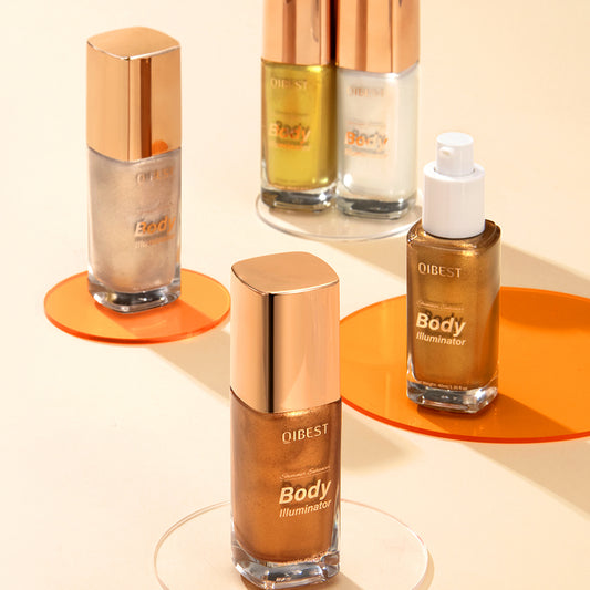 QIBEST illuminating body highlighter bottles in gold and silver shades with rose gold caps on transparent discs